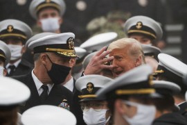 U.S. President Trump gestures as he stands among U.S. Navy cadets during the annual Army-Navy collegiate football game at Michie Stadium, in West Point