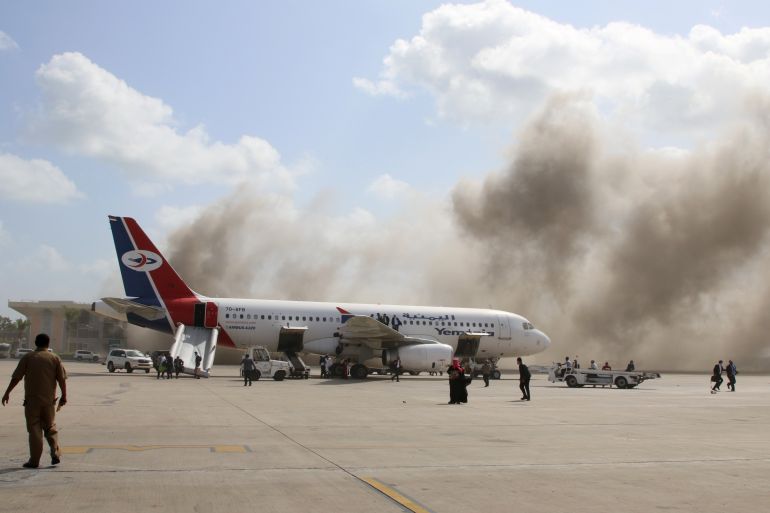 Dust rises after explosions hit Aden airport, upon the arrival of the newly-formed Yemeni government in Aden