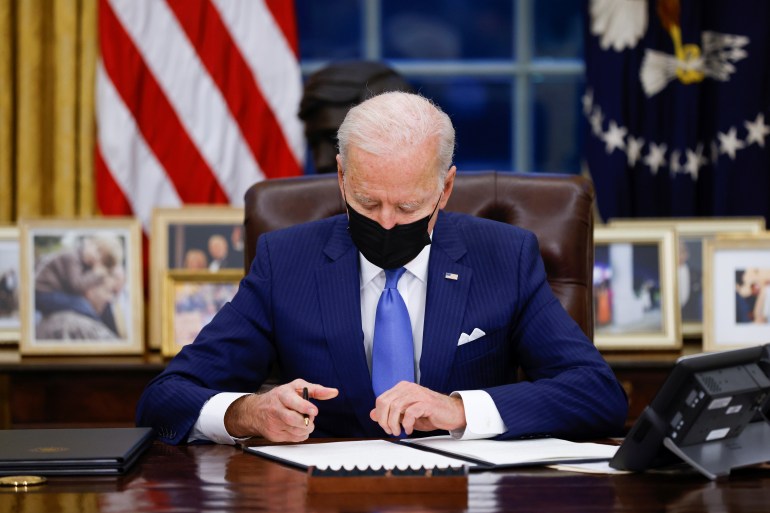 President Biden signs executive orders on immigration reform inside the Oval Office at the White House in Washington