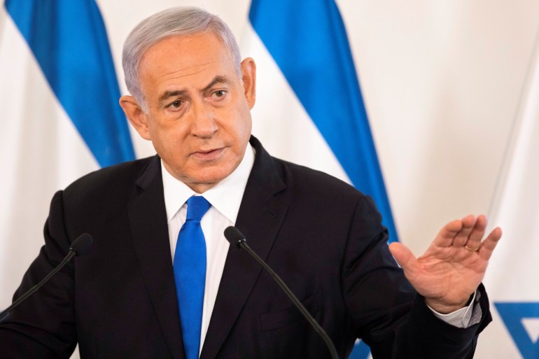 Israeli Prime Minister Benjamin Netanyahu gestures as he speaks during a briefing to ambassadors to Israel at a military base in Tel Aviv