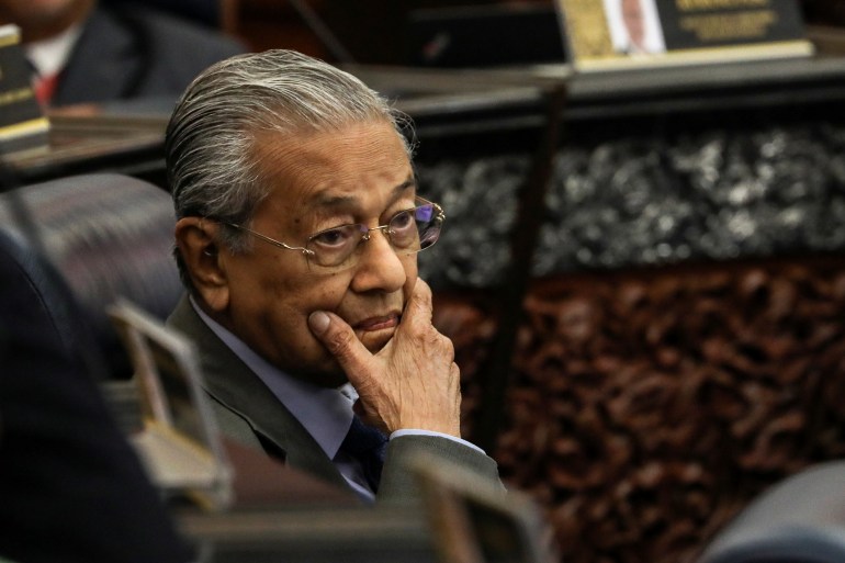 Malaysia's former Prime Minister Mahathir Mohamad reacts during a session of the lower house of parliament, in Kuala Lumpur