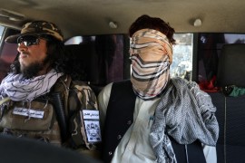 Suspected ISIS member sits blindfolded in a Taliban Special Forces' car in Kabul