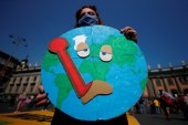 2021 年 7 月 22 日，在意大利那不勒斯举行二十国集团环境部长会议时，一名抗议者在示威中举着标语牌，要求采取更多行动（路透社）
