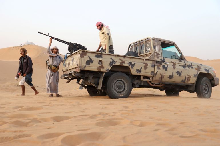 Armed men loyal to the government forces guard a site near the Safer oil fields in Marib