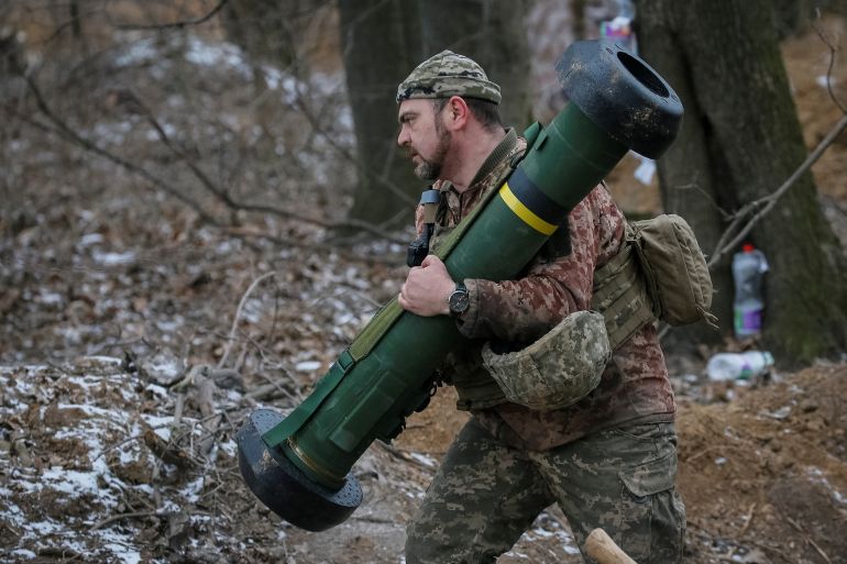 Ukrainian service member holds a Javelin missile system at a position on the front line in the north Kyiv region
