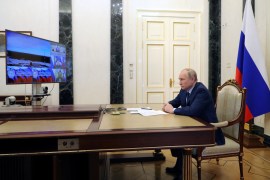 Russian President Vladimir Putin watches a test launch of the Sarmat intercontinental ballistic missile, via video link in Moscow