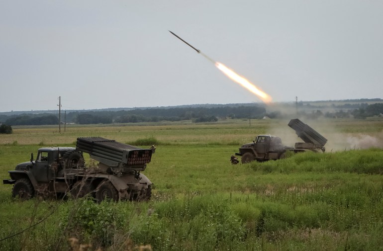 Ukrainian servicemen fire with a BM21 Grad multiple launch rocket system in a frontline in Kharkiv region