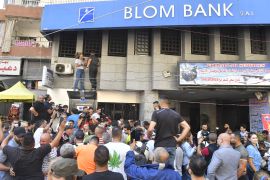 Lebanese man demanding his savings protest in a bank in Beirut